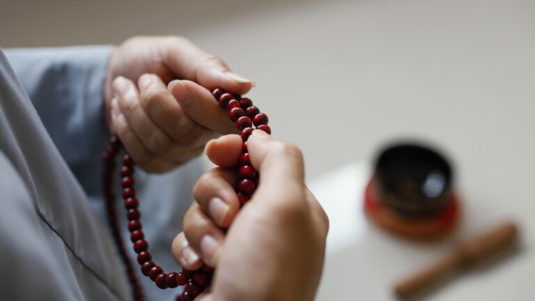 woman holding beads (tasbih) during spiritual practice related to ruqyah treatment