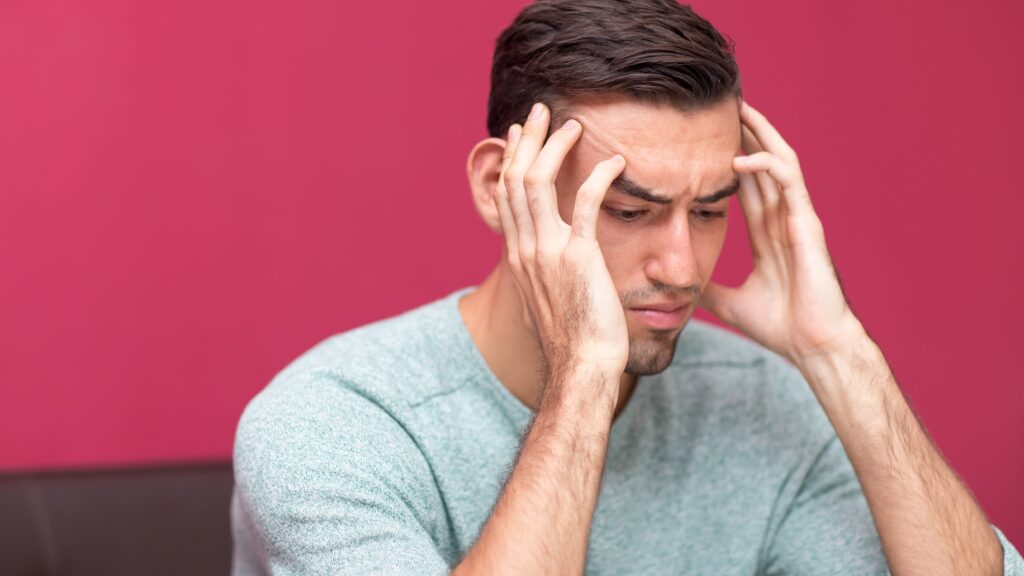 man tensed due to migraine